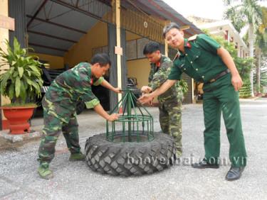 Thượng úy Khổng Quang Giản (người ngoài cùng, bên phải) đang cùng các cán bộ, chiến sỹ áp dụng sáng kiến vào thực tế.
