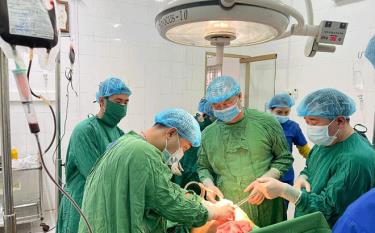 Medical workers at Van Yen health clinic perform an emergency surgery to save a patient with a wound in the stomach.