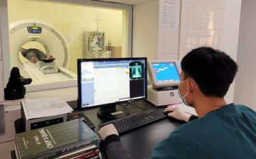 A recovered patient receives a lung check through a CT scanner.