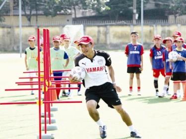 Danh thủ Hồng Sơn hướng dẫn các em nhỏ tham dự trại hè. 
