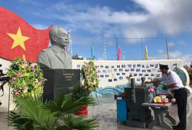 A soldier offers incense to General Vo Nguyen Giap at his statue on Son Ca island.