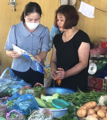 Đại lý thu phường Nguyễn Phúc, thành phố Yên Bái phát tờ rơi vận động tiểu thương tham gia bảo hiểm xã hội tự nguyện.