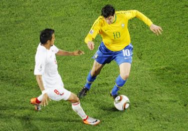 Kaka (số 10) đi bóng trước sự đeo bám của tiền vệ Arturo Vidal (Chile).