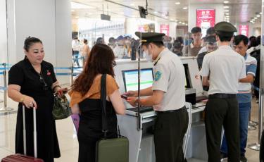 Lực lượng an ninh hàng không làm thủ tục cho hành khách tại sân bay Nội Bài Ảnh: PHAN CÔNG