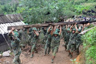 Các chiên sĩ giúp dân di dời nhà tại bản Phình Hồ, xã Dế Xu Phình.
