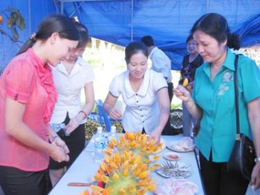 Khách hàng tham quan, nếm thử đặc sản Hồng không hạt, tại gian hàng trưng bày của huyện Ba Bể.  
