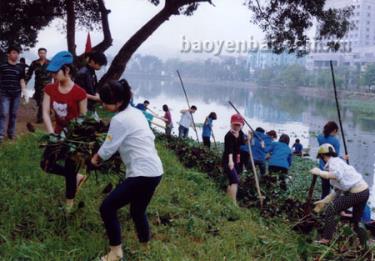 Đoàn viên thanh niên Thành phố Yên Bái thu dọn vệ sinh ở khu vực hồ công viên Yên Hòa.