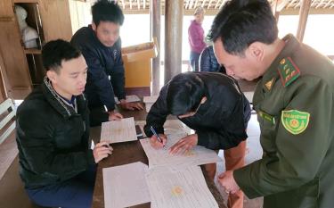 Cán bộ kiểm lâm huyện Lục Yên hướng dẫn người dân ký cam kết bảo vệ rừng, PCCCR.