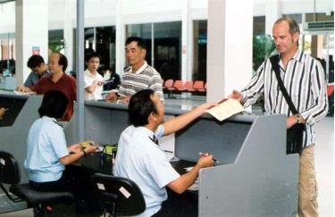 A customs official conducts immigration procedures for a foreigner at Tan Son Nhat airport in HCM City.