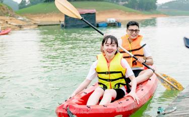 Visitors join activities at Thac Ba Lake tourist destination.