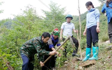 Đồng chí Hảng A Ký - Trưởng Ban Dân vận Huyện ủy, Chủ tịch Ủy ban MTTQ Việt Nam huyện Mù Cang Chải cùng người dân trồng cây đào rừng trong hoạt động 