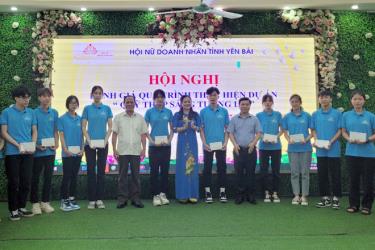 President of the provincial Women Entrepreneurs Association Bui Thi Suu and representatives from the locality’s Association for Learning Promotion and Department of Education and Training present the scholarships to 12 local students with extremely difficult circumstances.