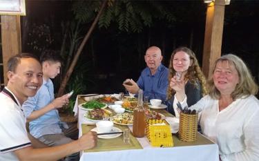 Du khách thích thú với các món ăn đặc sản tại Homestay Loan Khang ở thôn Sà Rèn, xã Nghĩa Lợi, thị xã Nghĩa Lộ.